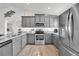 Gray kitchen with stainless steel appliances and granite countertops at 9194 Impala Cir, Port Charlotte, FL 33981