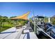 Private dock with seating area, shade sail, and boat slip at 9194 Impala Cir, Port Charlotte, FL 33981