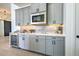 Gray shaker cabinets, quartz countertops, and beverage cooler at 8250 Arlewood Cir, Port Charlotte, FL 33981