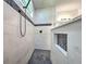 Modern bathroom with walk-in shower, pebble tile floor, and built-in niche at 8250 Arlewood Cir, Port Charlotte, FL 33981