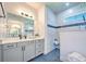 Elegant bathroom featuring a walk-in shower and gray vanity at 8250 Arlewood Cir, Port Charlotte, FL 33981