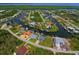 Aerial view of a waterfront home in a residential area at 8250 Arlewood Cir, Port Charlotte, FL 33981