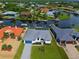 Aerial view of a canal-front home and neighborhood at 8250 Arlewood Cir, Port Charlotte, FL 33981