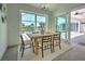 Bright dining room with sliding glass doors leading to a patio and water view at 8250 Arlewood Cir, Port Charlotte, FL 33981