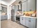Modern kitchen with gray cabinets and quartz countertops at 8250 Arlewood Cir, Port Charlotte, FL 33981