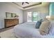 Main bedroom with pool view and large dresser at 8250 Arlewood Cir, Port Charlotte, FL 33981