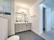 Bathroom with vanity, walk-in shower, and closet access at 8250 Arlewood Cir, Port Charlotte, FL 33981