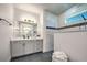Bathroom with walk-in shower, vanity, and dark floors at 8250 Arlewood Cir, Port Charlotte, FL 33981
