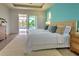 Main bedroom with water view, king bed, and sliding glass doors at 8250 Arlewood Cir, Port Charlotte, FL 33981