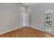 Bright bedroom with wood-look floors and access to a bathroom at 26021 Templar Ln, Punta Gorda, FL 33983
