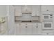 White kitchen cabinets and appliances, with a built in microwave at 26021 Templar Ln, Punta Gorda, FL 33983