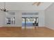 Spacious living room with hardwood floors and pool access at 26021 Templar Ln, Punta Gorda, FL 33983