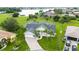 Aerial view of a house with pool and lake view in a residential area at 26021 Templar Ln, Punta Gorda, FL 33983