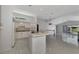 Kitchen with white cabinets, tile floor and breakfast bar at 26021 Templar Ln, Punta Gorda, FL 33983