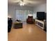 Relaxing living room showcasing tile floors, access to balcony, ceiling fan and comfortable lounging area at 1515 Forrest Nelson Blvd # A208, Port Charlotte, FL 33952