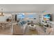 Bright living room with water views, wicker furniture, and TV at 5850 Gasparilla Rd # M1&3, Boca Grande, FL 33921