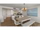 Bright dining area with kitchen access and white furniture at 5850 Gasparilla Rd # M1&3, Boca Grande, FL 33921