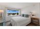 Bright bedroom with water views and comfortable bedding at 5850 Gasparilla Rd # M1&3, Boca Grande, FL 33921