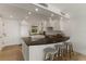 Modern kitchen with white cabinets, dark countertops, and stainless steel appliances at 5850 Gasparilla Rd # M1&3, Boca Grande, FL 33921
