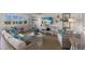 Bright living room features wicker furniture, a large TV, and stylish coastal decor at 5850 Gasparilla Rd # M1&3, Boca Grande, FL 33921
