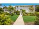 Gray building with lush landscaping and stairs at 5850 Gasparilla Rd # M1&3, Boca Grande, FL 33921