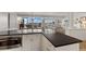 Modern kitchen with white cabinets, dark countertops, and a breakfast bar at 5850 Gasparilla Rd # M1&3, Boca Grande, FL 33921