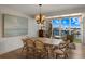 Bright dining room with a wooden table, wicker chairs, and waterfront views at 5850 Gasparilla Rd # M1&3, Boca Grande, FL 33921