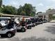 Row of golf carts parked outside clubhouse at 26724 Weiskopf Dr, Englewood, FL 34223