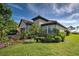 Landscaped yard with lush greenery surrounding the home's exterior at 26724 Weiskopf Dr, Englewood, FL 34223