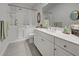 Bathroom with walk-in shower, soaking tub, and vanity with ample storage at 26724 Weiskopf Dr, Englewood, FL 34223