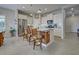 Bright kitchen with white cabinets, island seating, and stainless steel appliances at 26724 Weiskopf Dr, Englewood, FL 34223