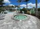 Relaxing community spa with tiled deck and seating at 26724 Weiskopf Dr, Englewood, FL 34223