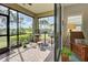 Peaceful screened porch with view of the backyard and nature at 26724 Weiskopf Dr, Englewood, FL 34223