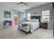 Bright bedroom with tiled floors, a sliding barn door, and a comfortable bed at 26724 Weiskopf Dr, Englewood, FL 34223