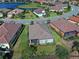Aerial view of the back of a house with a screened enclosure at 26724 Weiskopf Dr, Englewood, FL 34223