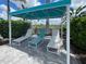 Poolside cabana with comfortable lounge chairs at 26724 Weiskopf Dr, Englewood, FL 34223