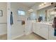 Modern accessible bathroom with a walk-in shower and double vanity at 26724 Weiskopf Dr, Englewood, FL 34223