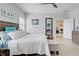 Large bedroom with a comfortable bed, tiled floors, and access to another room at 26724 Weiskopf Dr, Englewood, FL 34223