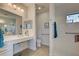 Well-lit bathroom with accessible features, including grab bars and a roll-in shower at 26724 Weiskopf Dr, Englewood, FL 34223