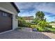 Home's front features a dark brown garage door and a brick driveway at 26724 Weiskopf Dr, Englewood, FL 34223
