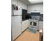 Cozy kitchen with white cabinets, updated appliances, and tile flooring at 1515 Forrest Nelson Blvd # A208, Port Charlotte, FL 33952