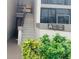 Exterior view of a condo building with stairs and landscaping at 1515 Forrest Nelson Blvd # A208, Port Charlotte, FL 33952