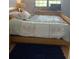 Relaxing bedroom, featuring a wood bed frame and a navy blue rug at 1515 Forrest Nelson Blvd # A208, Port Charlotte, FL 33952