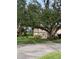 Building exterior showcasing landscaping and trees at 1515 Forrest Nelson Blvd # A208, Port Charlotte, FL 33952