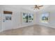 Bonus room with tiled floor, many windows, and a door to the backyard at 600 Bramblewood Ln, Englewood, FL 34223