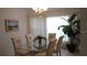 Bright dining room featuring a glass-top table and four chairs at 15001 Appleton Blvd, Port Charlotte, FL 33981