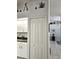 Kitchen with white cabinets, pantry, and view to living room at 15001 Appleton Blvd, Port Charlotte, FL 33981