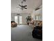 Spacious living room featuring a ceiling fan and access to a patio at 15001 Appleton Blvd, Port Charlotte, FL 33981