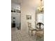 Dining room with glass table, chairs and view into the kitchen at 15001 Appleton Blvd, Port Charlotte, FL 33981