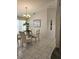 Bright dining room with a glass-top table and four chairs at 15001 Appleton Blvd, Port Charlotte, FL 33981